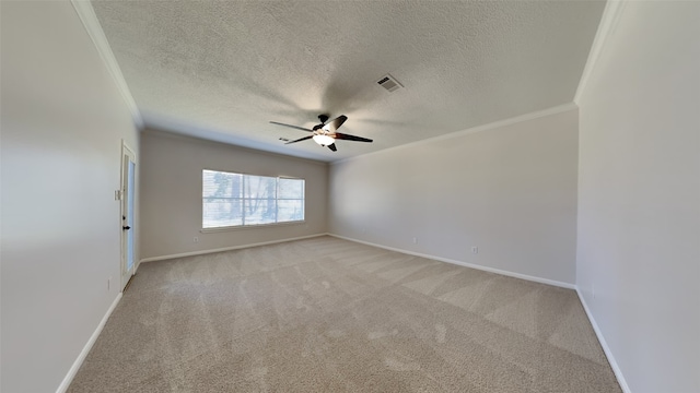 spare room with visible vents, light carpet, a ceiling fan, crown molding, and baseboards