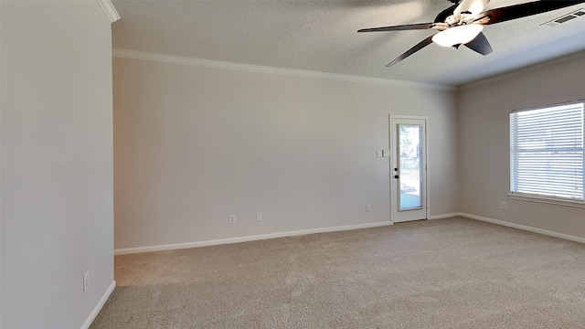 empty room with visible vents, light carpet, and crown molding