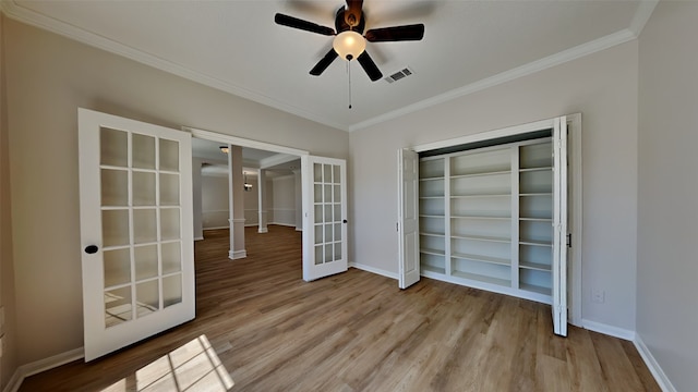 unfurnished room featuring visible vents, a ceiling fan, wood finished floors, french doors, and crown molding