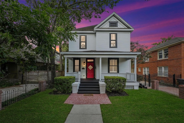 view of front facade featuring a porch, a yard, and fence