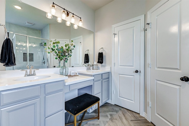 full bath featuring a sink, visible vents, double vanity, and a shower stall