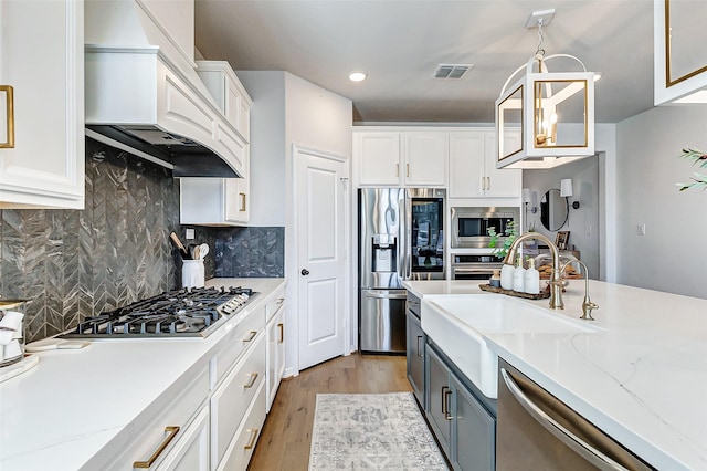 kitchen with white cabinets, visible vents, and appliances with stainless steel finishes