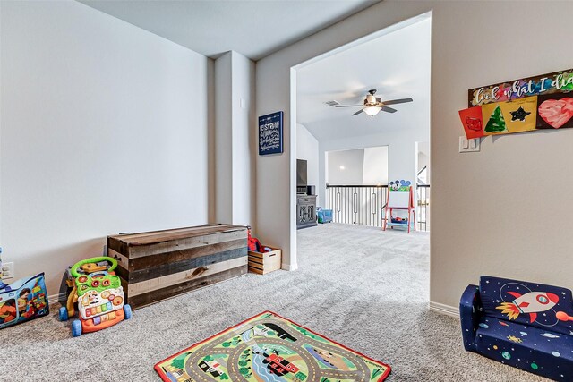 rec room featuring ceiling fan, baseboards, and carpet