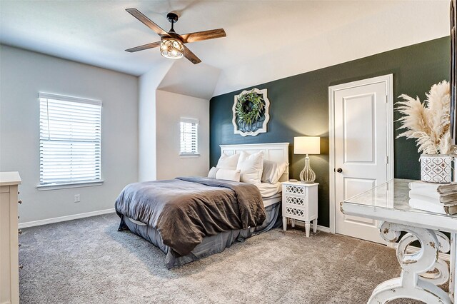 carpeted bedroom with a ceiling fan, lofted ceiling, and baseboards