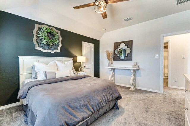 bedroom featuring visible vents, carpet flooring, baseboards, and vaulted ceiling