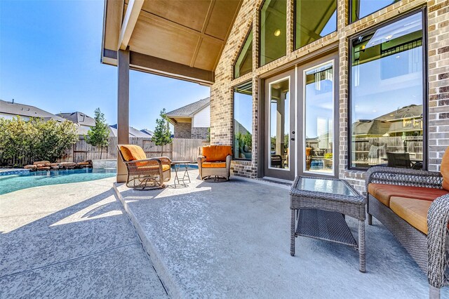 view of patio with a fenced in pool and fence