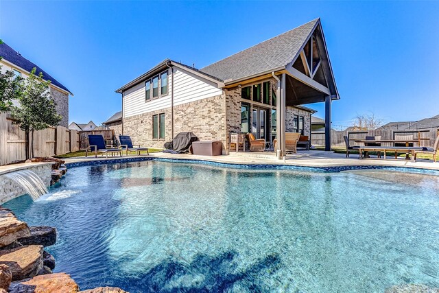 view of swimming pool featuring a fenced in pool, a fenced backyard, and a patio area