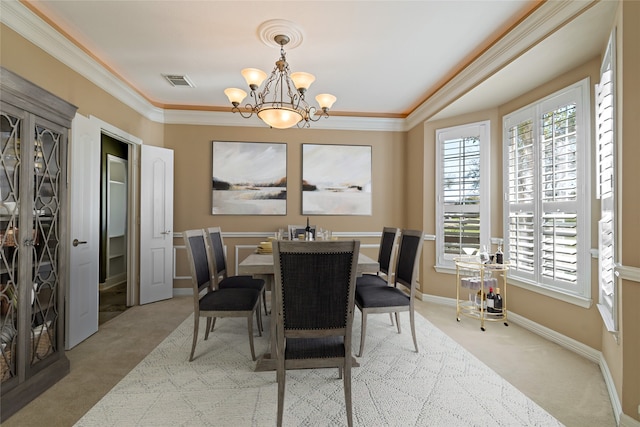 carpeted dining room featuring crown molding, baseboards, visible vents, and a chandelier