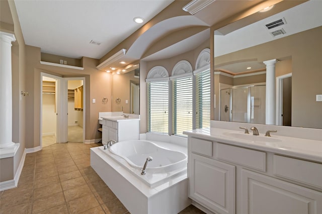 bathroom featuring a sink, visible vents, a stall shower, and ornate columns