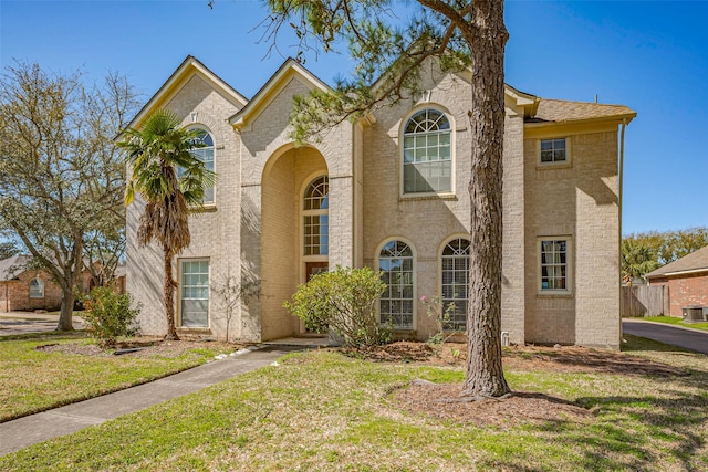 view of front of property featuring brick siding and a front yard