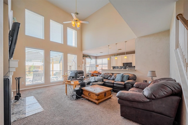 living room featuring a fireplace, ceiling fan, and carpet floors