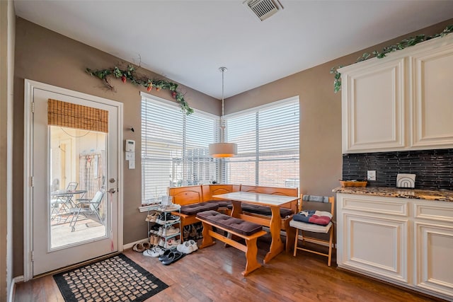 dining space with visible vents and light wood-style flooring