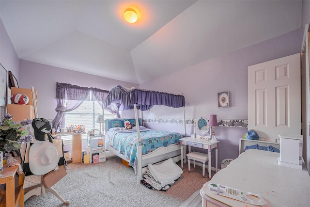 carpeted bedroom with lofted ceiling