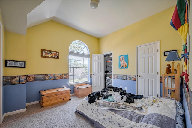 carpeted bedroom with baseboards and lofted ceiling