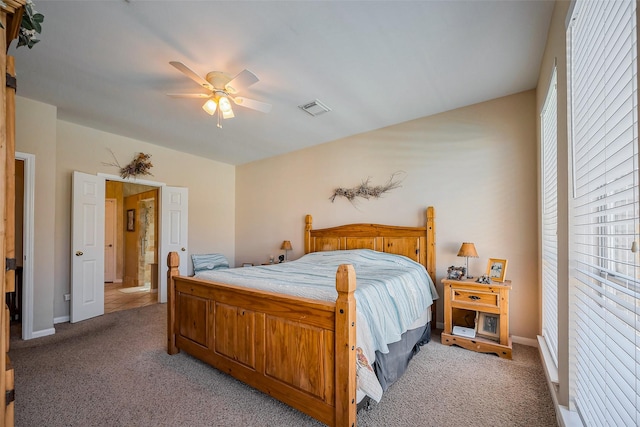 bedroom featuring visible vents, light carpet, baseboards, and a ceiling fan