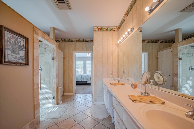 ensuite bathroom featuring visible vents, a stall shower, and a sink