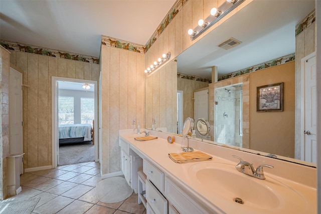 full bath with visible vents, ensuite bath, double vanity, a stall shower, and a sink