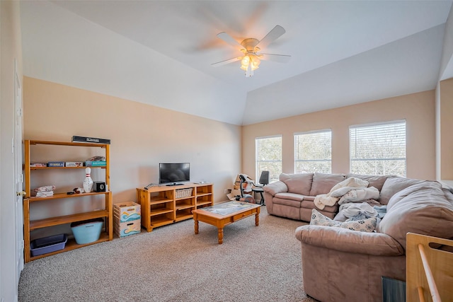 carpeted living area featuring a ceiling fan and vaulted ceiling