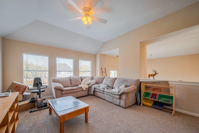 carpeted living room featuring baseboards, ceiling fan, and vaulted ceiling