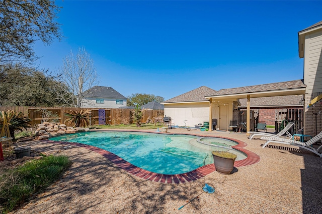 view of swimming pool featuring a patio area, a fenced backyard, and a pool with connected hot tub