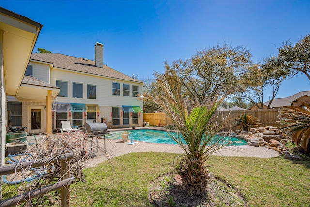 view of swimming pool with a fenced in pool, a lawn, a fenced backyard, and a patio area