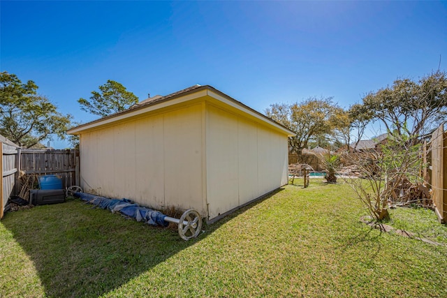 view of side of property with a yard and a fenced backyard