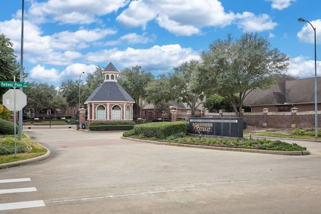 view of property's community with a gate and fence