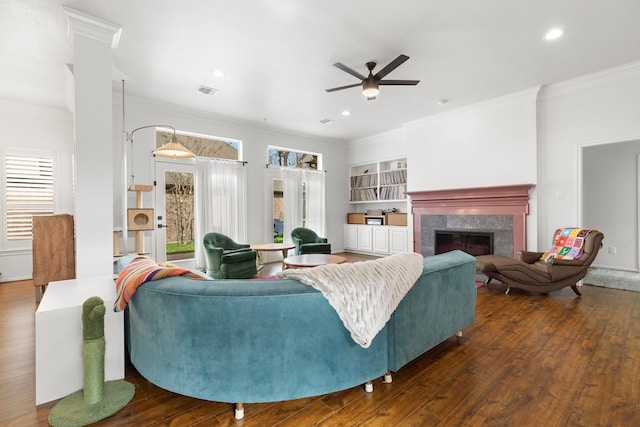 living room with hardwood / wood-style flooring, a wealth of natural light, and ornamental molding