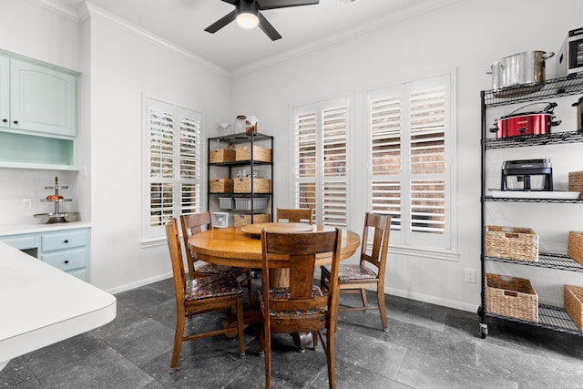 dining space featuring baseboards, plenty of natural light, and crown molding