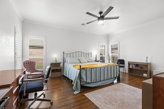 bedroom with visible vents, ornamental molding, ceiling fan, and wood finished floors