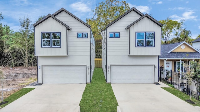 view of front of home with board and batten siding, a garage, and fence