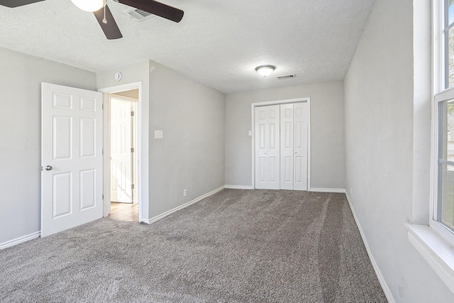 unfurnished bedroom with visible vents, carpet floors, and baseboards