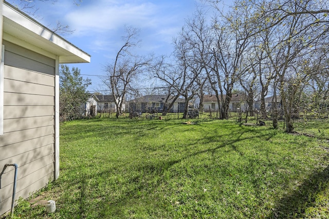 view of yard featuring a residential view and fence