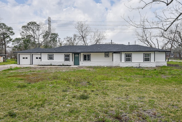 single story home with a front yard, an attached garage, and driveway