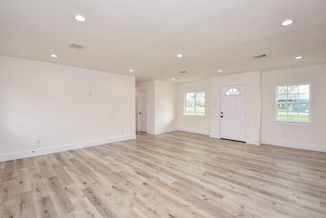 foyer featuring light wood finished floors, visible vents, recessed lighting, and baseboards