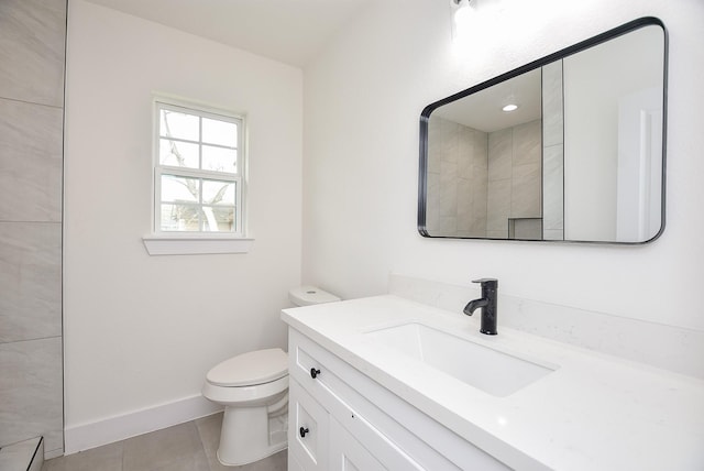 bathroom with tile patterned floors, baseboards, toilet, and vanity