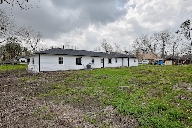 rear view of property with central AC