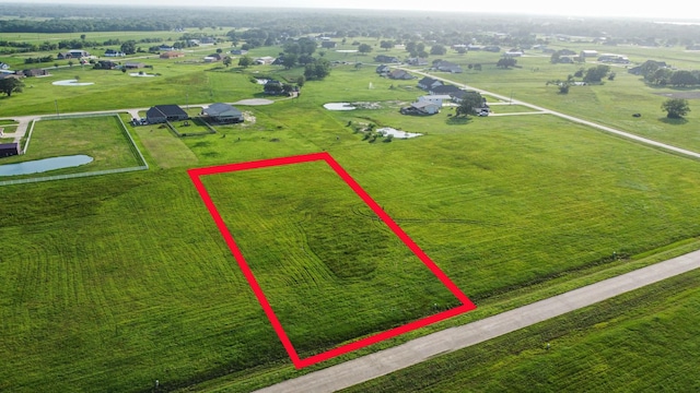 birds eye view of property with a rural view