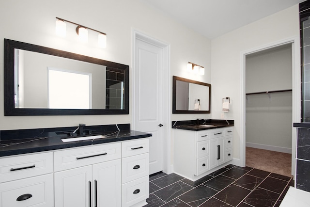 full bathroom with two vanities and a sink