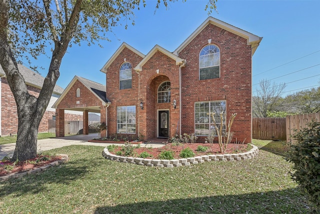 traditional home featuring brick siding, a front lawn, fence, a carport, and driveway