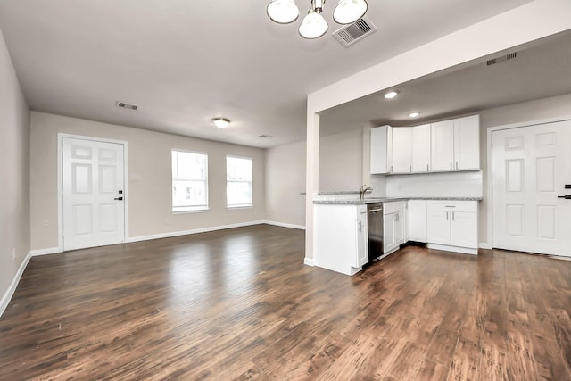 kitchen with open floor plan, dark wood-style floors, and visible vents