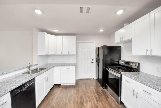 kitchen with visible vents, dark wood-style flooring, a sink, black appliances, and white cabinets