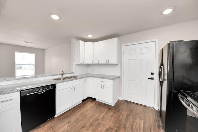 kitchen featuring dark wood-style floors, light stone countertops, a sink, black appliances, and white cabinets