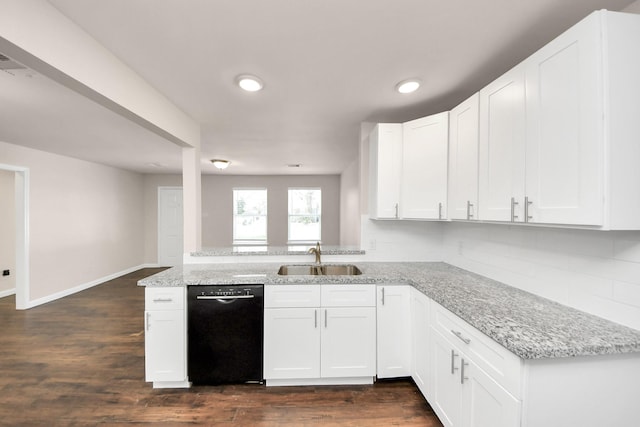 kitchen with a sink, light stone counters, black dishwasher, and white cabinetry