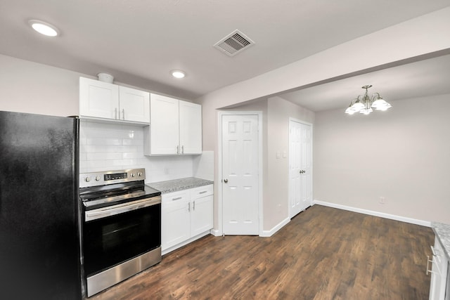 kitchen featuring visible vents, stainless steel electric range, freestanding refrigerator, dark wood-type flooring, and white cabinets