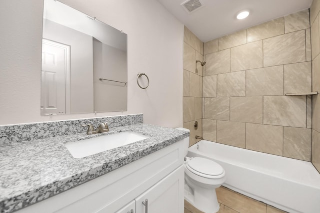 bathroom featuring tile patterned floors, visible vents, toilet, bathtub / shower combination, and vanity