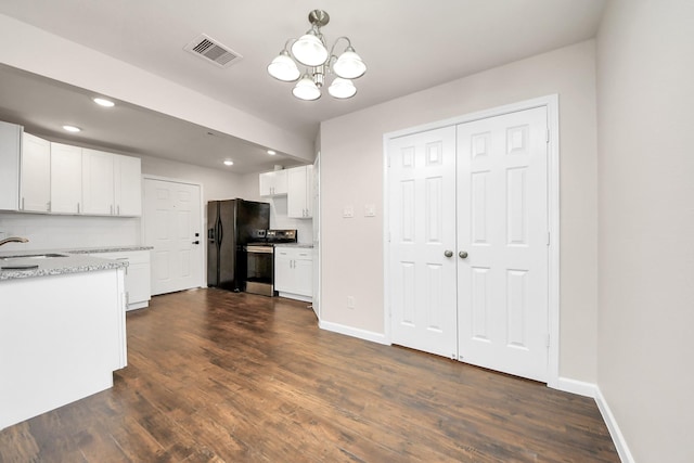 kitchen with visible vents, baseboards, dark wood finished floors, stainless steel range with electric stovetop, and white cabinetry