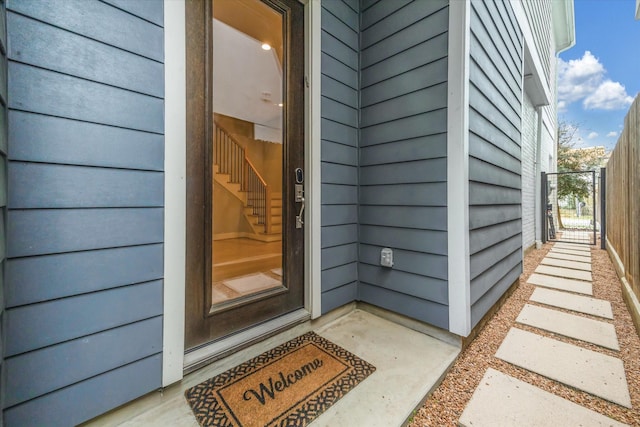 entrance to property featuring fence