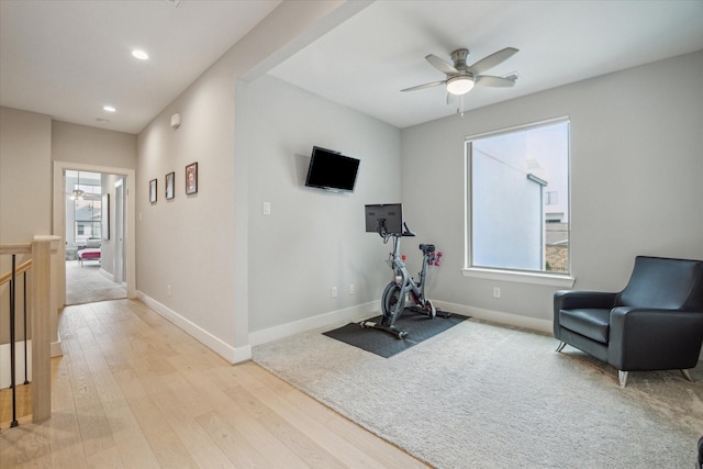 exercise room featuring recessed lighting, baseboards, light wood-style floors, and a ceiling fan