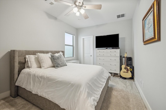 bedroom with baseboards, visible vents, and light carpet